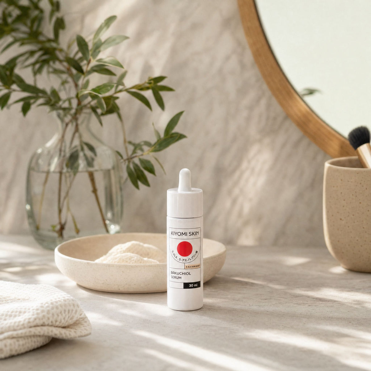 Kiyomi Skin Bakuchiol Serum on a sunlit bathroom counter beside ceramics and greenery